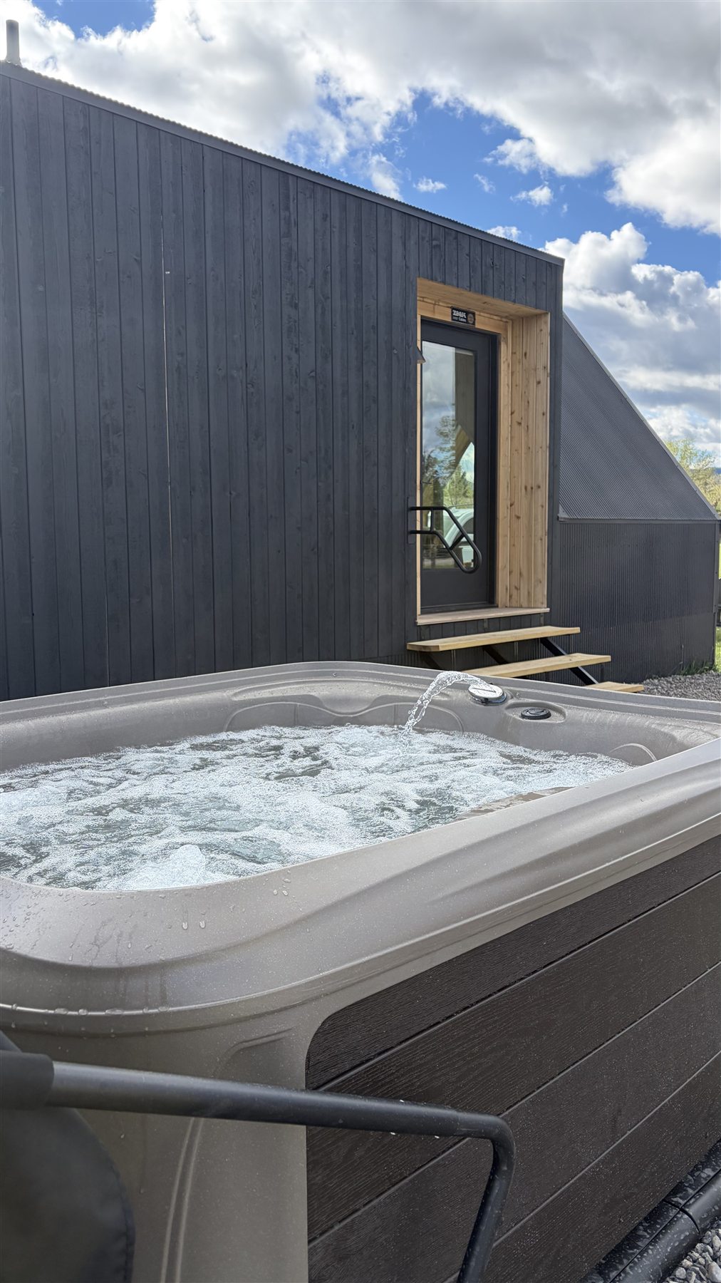 Cabin entry and hot tub at Glacier Mountain Getaway Bozeman