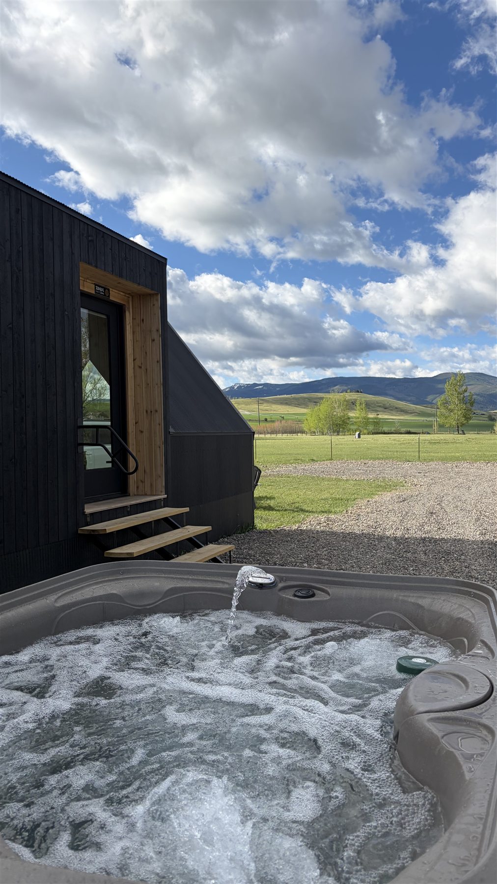Hot tub with mountain view at Glacier Mountain Getaway Bozeman