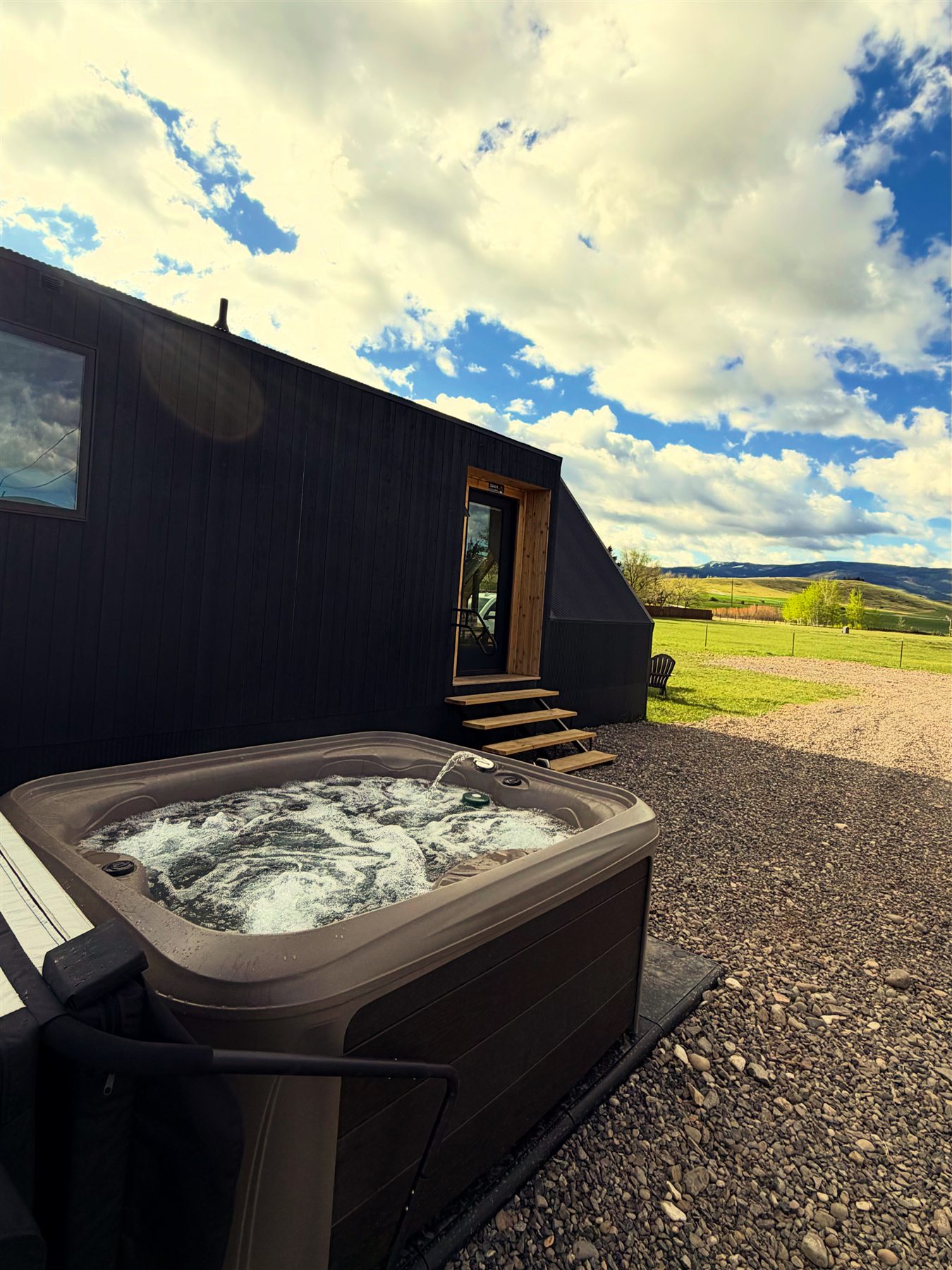 Outdoor hot tub patio at Glacier Mountain Getaway in Montana