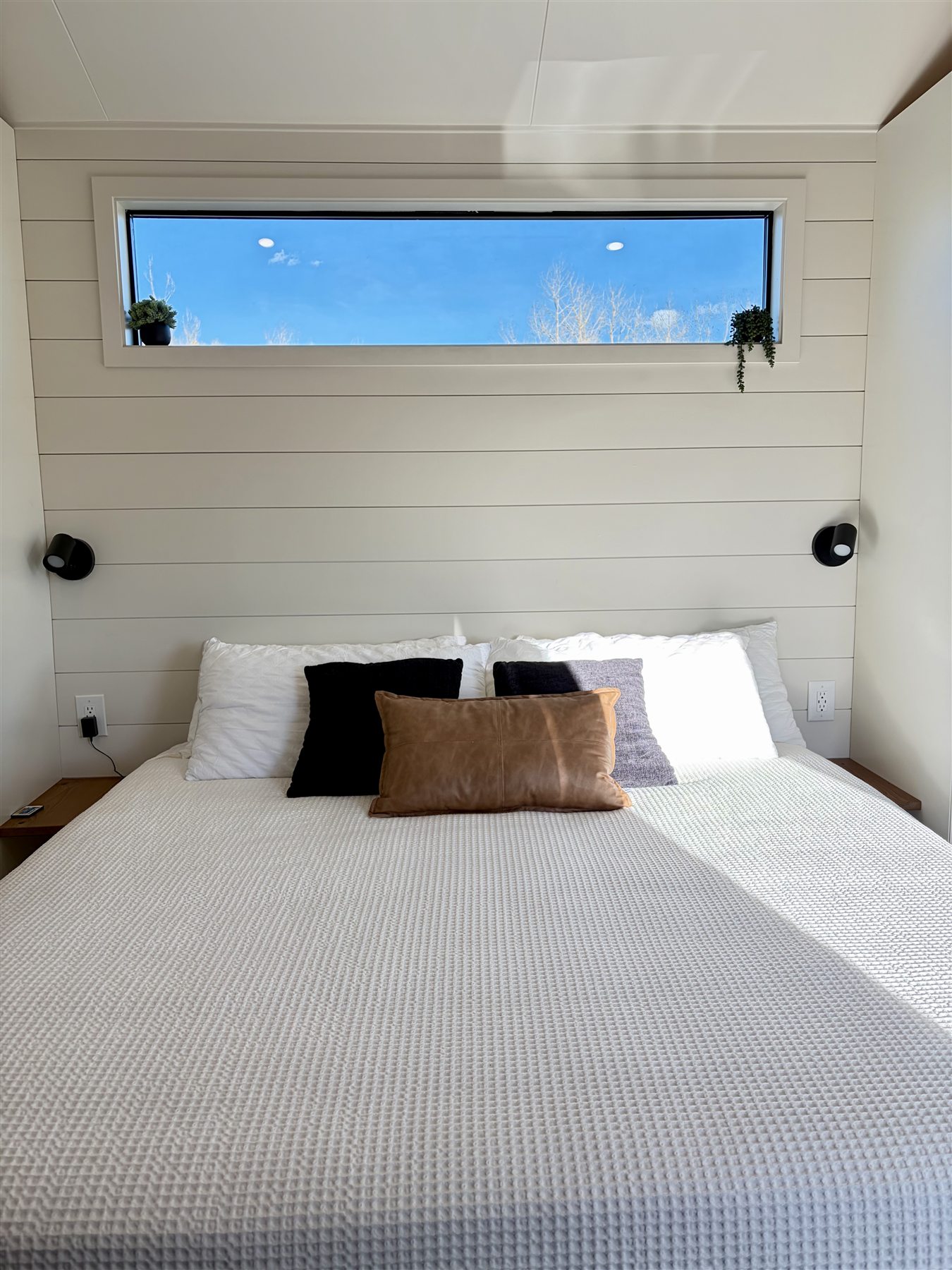 King bed with mountain window at Glacier Mountain Getaway Bozeman