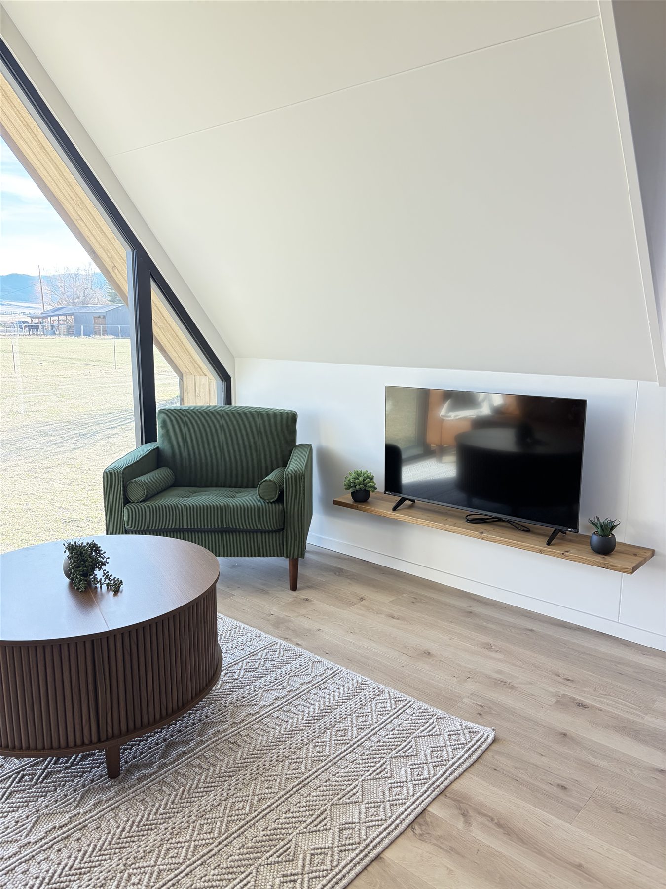 Living room sofa and television at Glacier Mountain Getaway