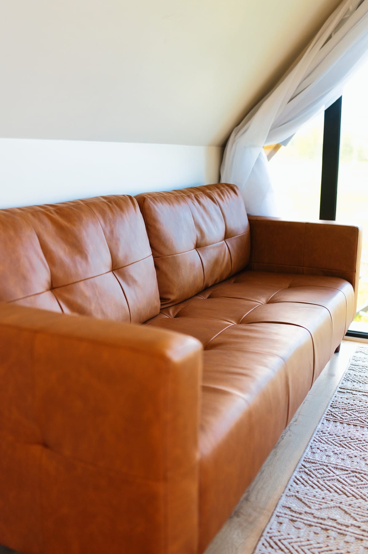 Comfortable couch in the living room at Glacier Mountain Getaway near Bozeman Montana